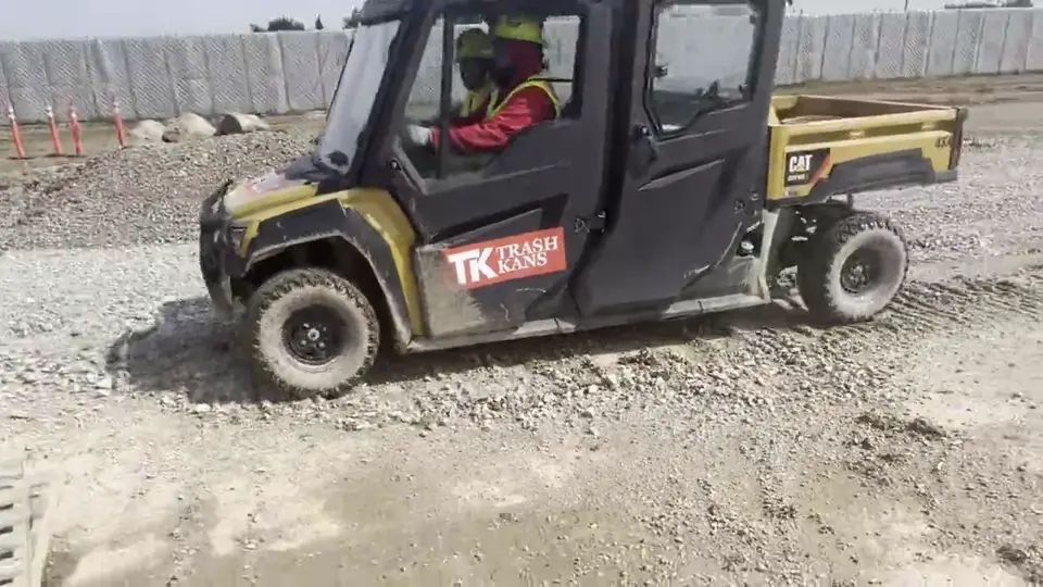 A site vehicle crossing an active construction site.